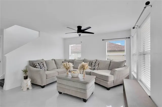 a living room with furniture and a large window