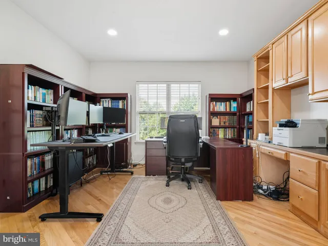 a work space with furniture a rug and a window