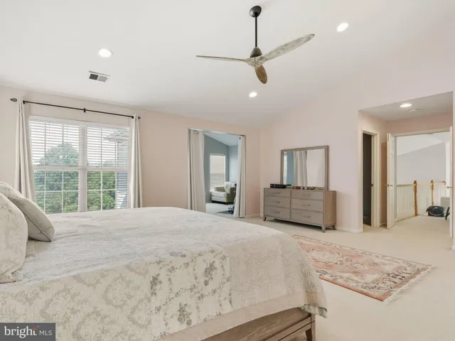 a large bedroom with a large bed and a large window