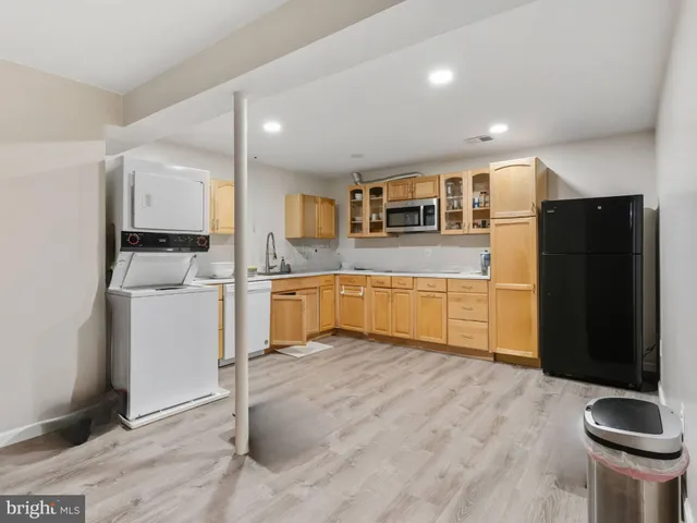 a kitchen with a refrigerator sink and stove