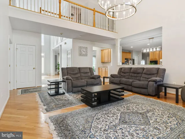a living room with furniture a rug and a chandelier