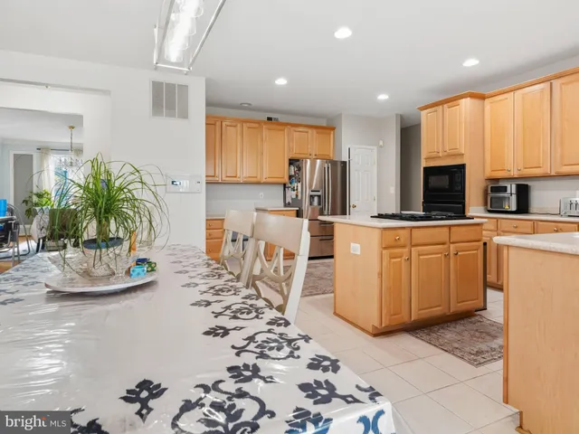 a kitchen with sink a microwave and cabinets