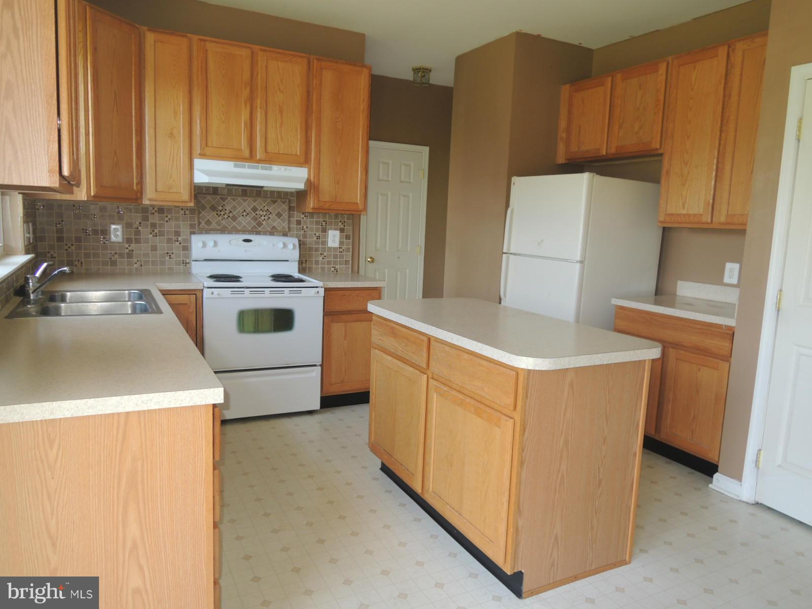 45 Boise Road Inwood, WV 25428 - Photo 13 of 30 a kitchen with stainless steel appliances a refrigerator stove and sink