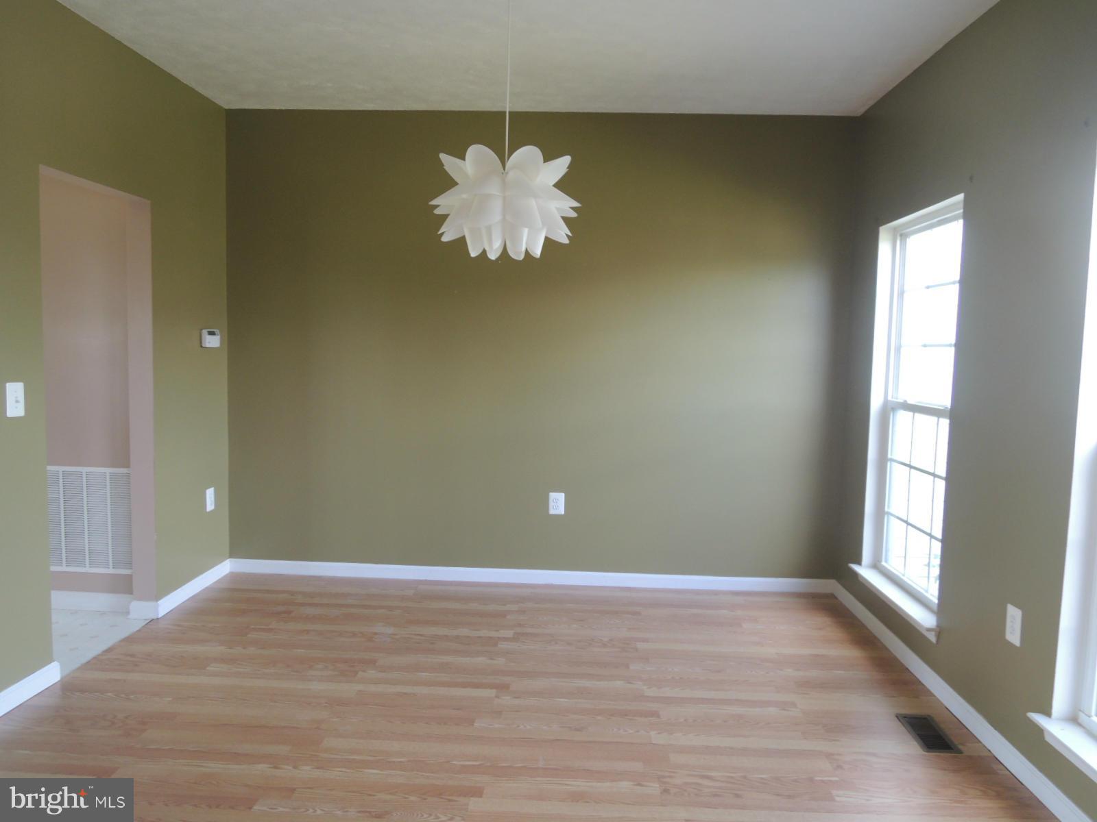 45 Boise Road Inwood, WV 25428 - Photo 6 of 30 a view of a room with a wooden floor and a ceiling fan