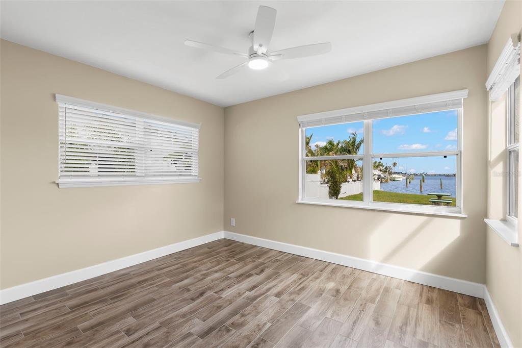 708 Sunset Cove Madeira Beach, FL 33708 - Photo 25 of 61 a view of an empty room with wooden floor and a window