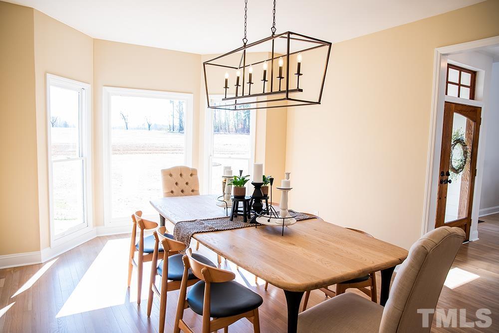 433 Noah Davis Road Roxboro, NC 27574 - Photo 20 of 95 a view of a dining room with furniture and wooden floor