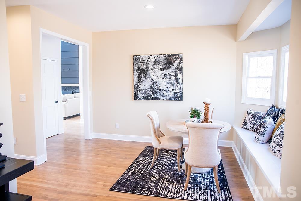433 Noah Davis Road Roxboro, NC 27574 - Photo 32 of 95 a view of a dining room with furniture window and wooden floor