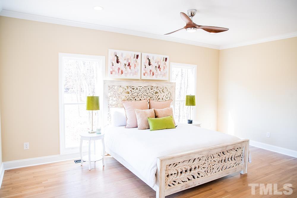 433 Noah Davis Road Roxboro, NC 27574 - Photo 34 of 95 a bedroom with a bed and a painting on the wall