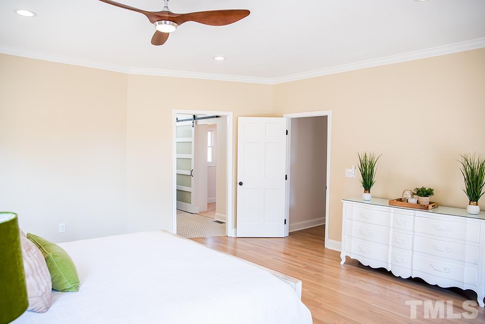 433 Noah Davis Road Roxboro, NC 27574 - Photo 36 of 95 a bedroom with a bed and a dresser