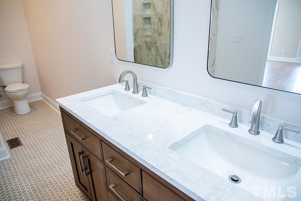 433 Noah Davis Road Roxboro, NC 27574 - Photo 40 of 95 a bathroom with a sink and a mirror