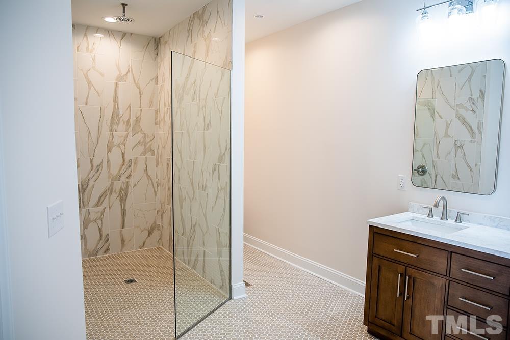 433 Noah Davis Road Roxboro, NC 27574 - Photo 41 of 95 a bathroom with a shower and a sink