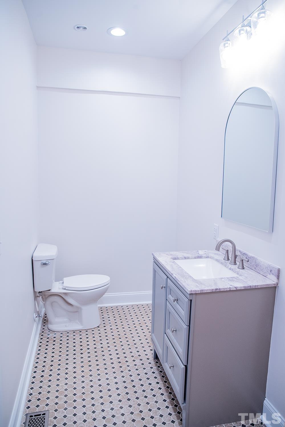 433 Noah Davis Road Roxboro, NC 27574 - Photo 51 of 95 a bathroom with a sink a toilet and a mirror