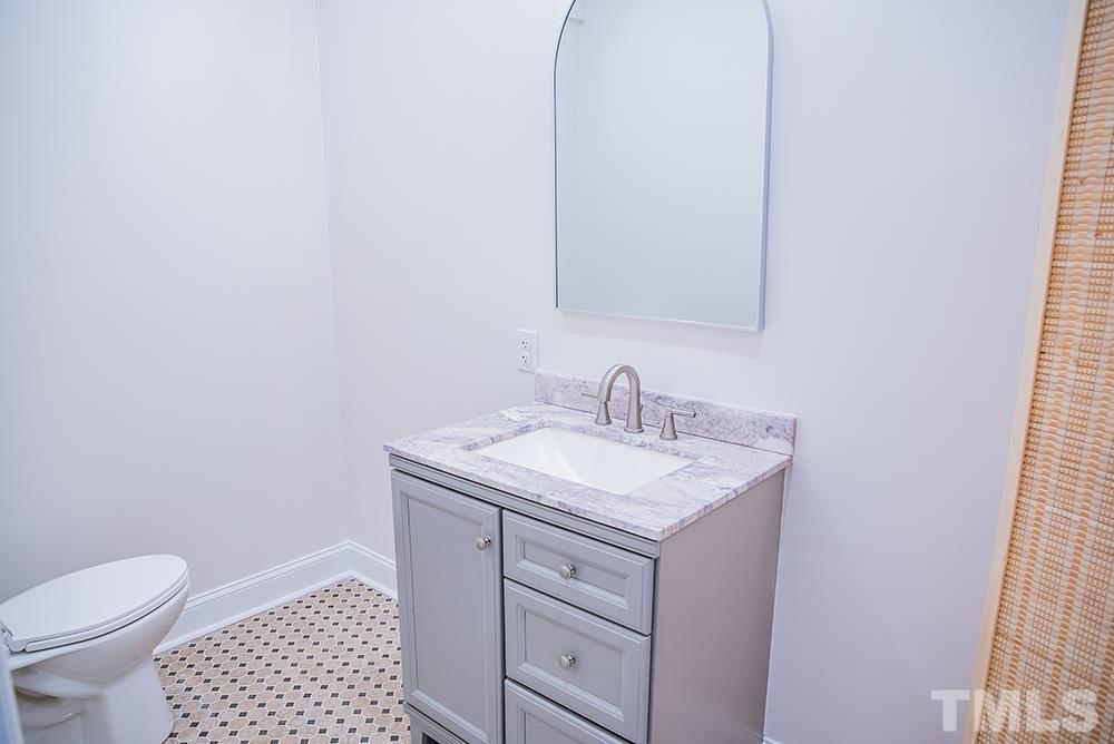 433 Noah Davis Road Roxboro, NC 27574 - Photo 53 of 95 a bathroom with a granite countertop sink toilet and a mirror