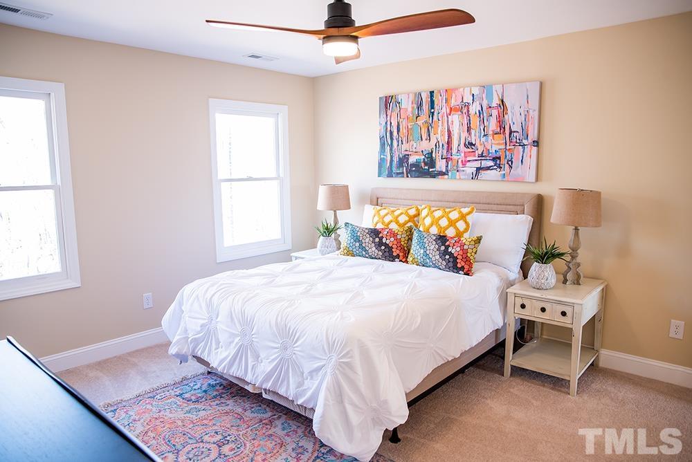 433 Noah Davis Road Roxboro, NC 27574 - Photo 59 of 95 a bedroom with a bed and a painting on the wall