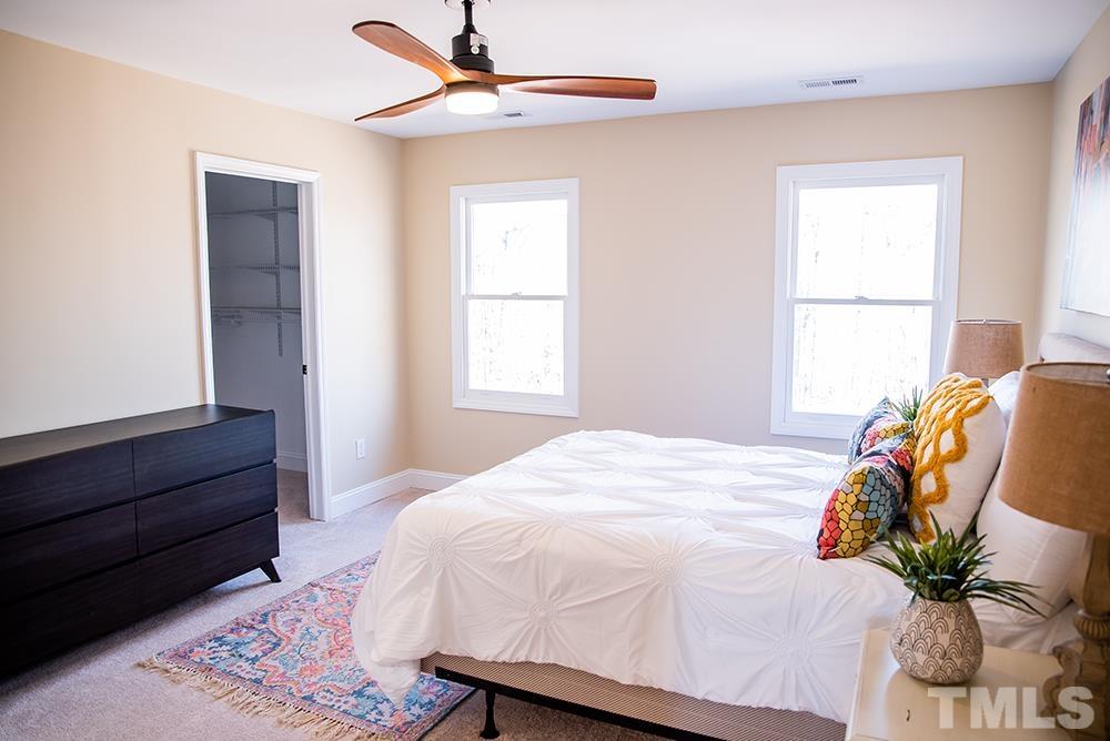 433 Noah Davis Road Roxboro, NC 27574 - Photo 60 of 95 a bedroom with a bed and wooden floor