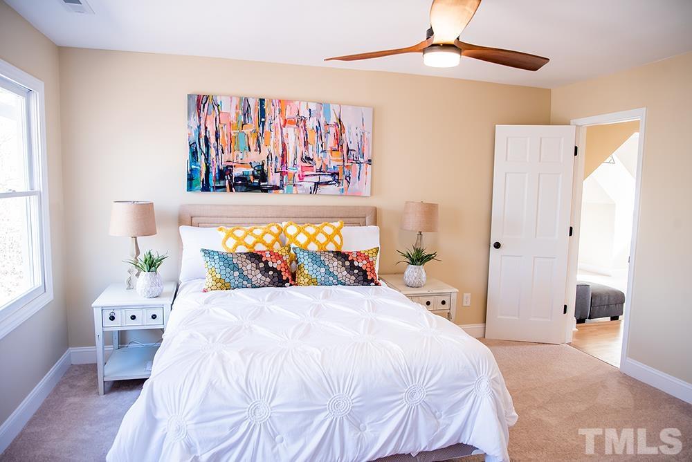 433 Noah Davis Road Roxboro, NC 27574 - Photo 61 of 95 a bedroom with a bed and a painting on the wall