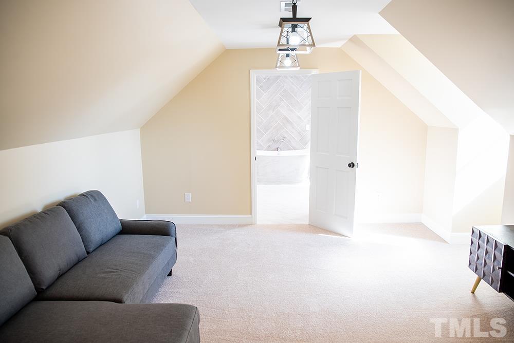 433 Noah Davis Road Roxboro, NC 27574 - Photo 62 of 95 a living room with furniture and a chandelier