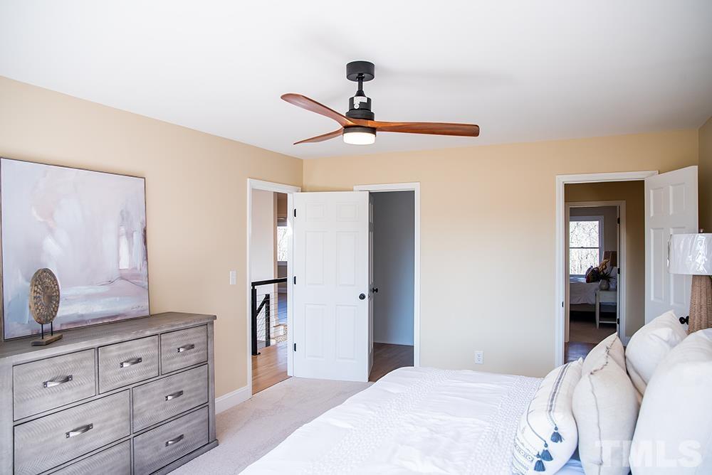 433 Noah Davis Road Roxboro, NC 27574 - Photo 65 of 95 a bedroom with a chandelier and a dresser