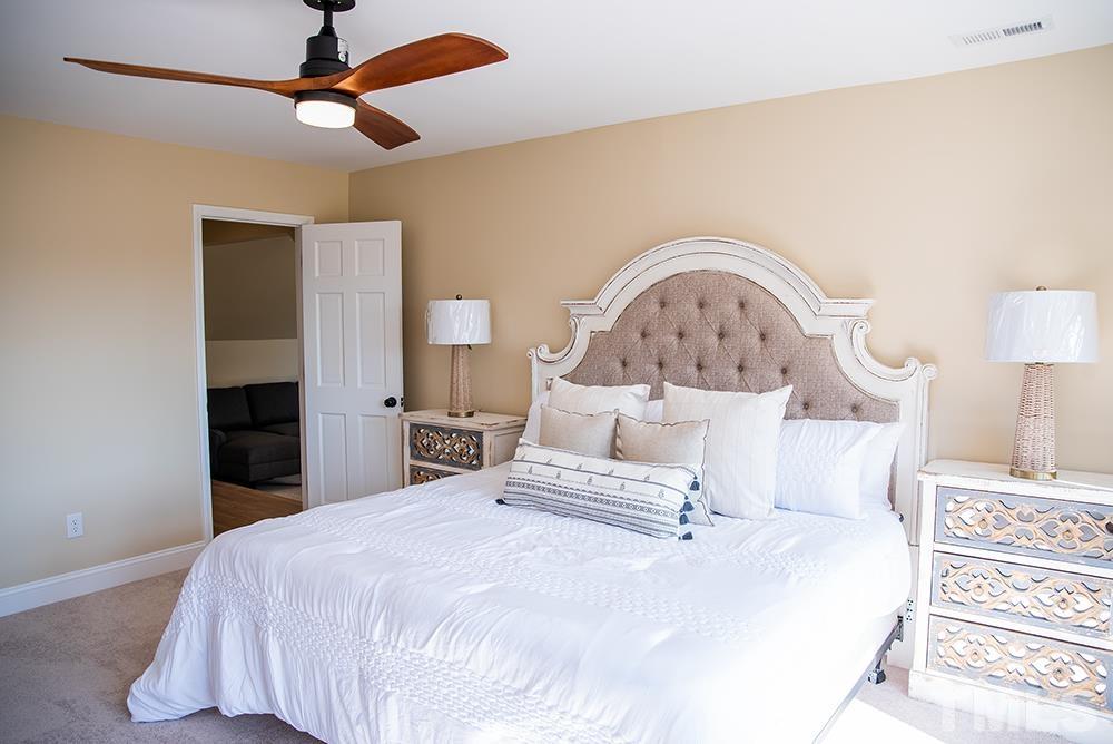 433 Noah Davis Road Roxboro, NC 27574 - Photo 66 of 95 a large bed sitting in a bedroom and a lamp