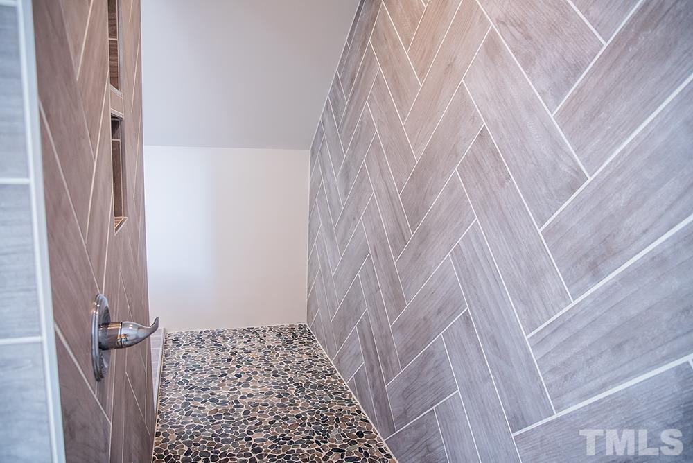 433 Noah Davis Road Roxboro, NC 27574 - Photo 74 of 95 a bathroom with a sink and a shower