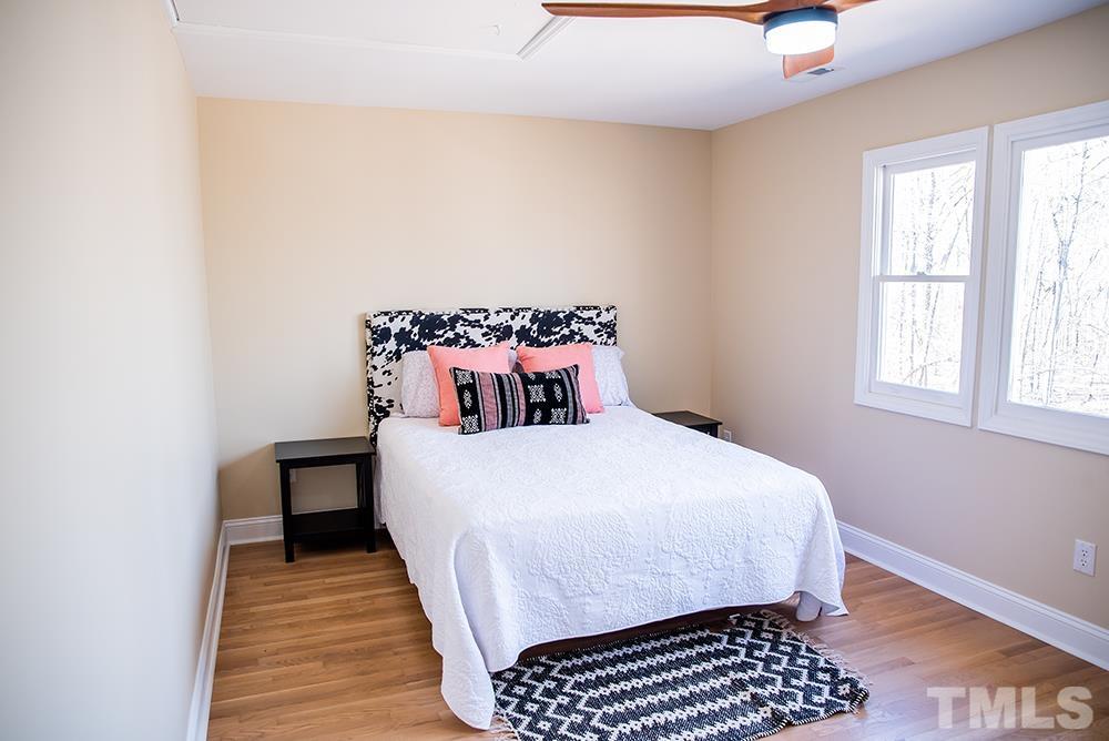 433 Noah Davis Road Roxboro, NC 27574 - Photo 77 of 95 a bedroom with a bed and wooden floor