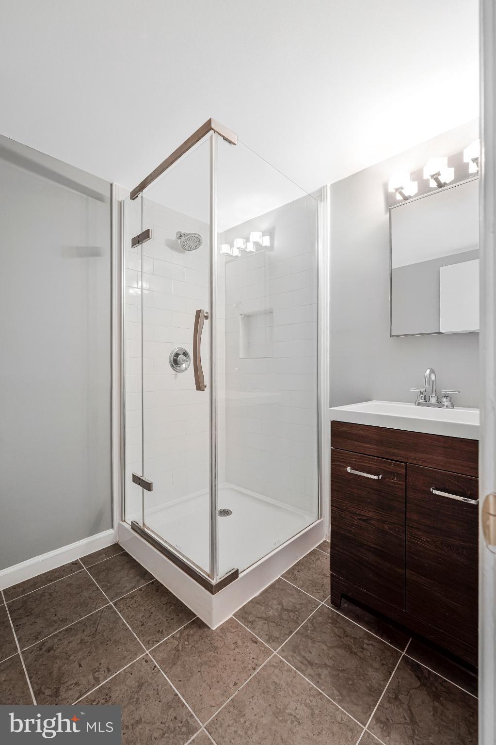 8330 Darlington Court, Unit 467 Springfield, VA 22152 - Photo 12 of 23 Sleek modern bathroom with glass shower.