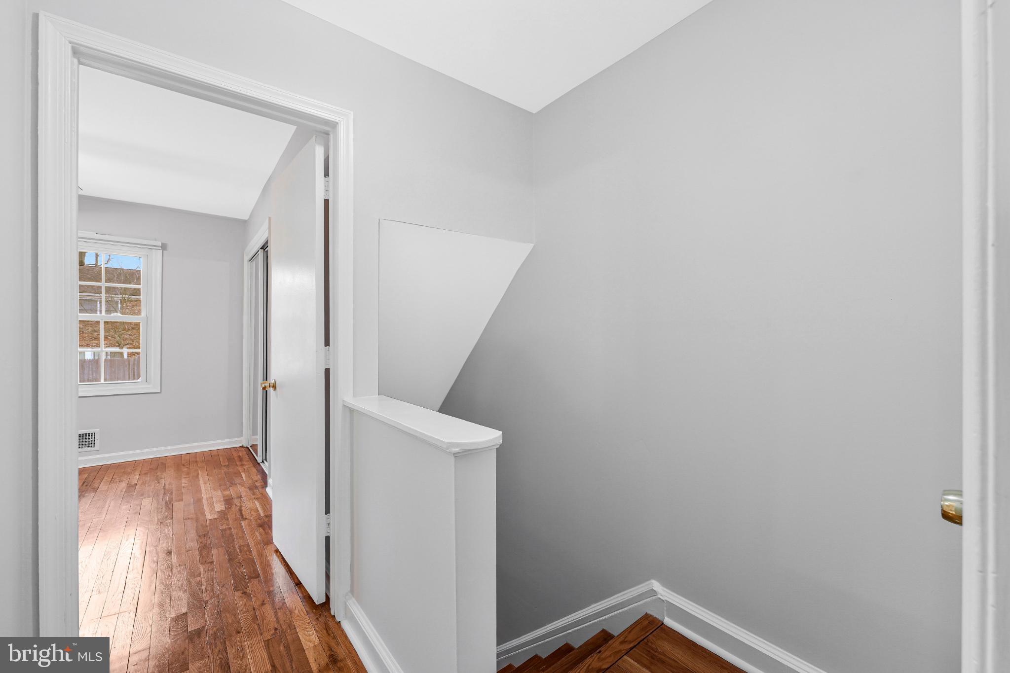 8330 Darlington Court, Unit 467 Springfield, VA 22152 - Photo 13 of 23 Bright and airy hallway with warm wood floors.
