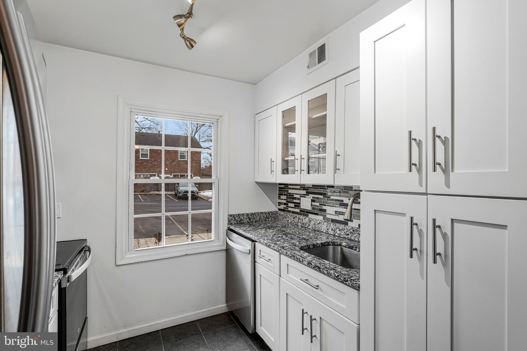 8330 Darlington Court, Unit 467 Springfield, VA 22152 - Photo 7 of 23 Bright and modern kitchen with sleek finishes.