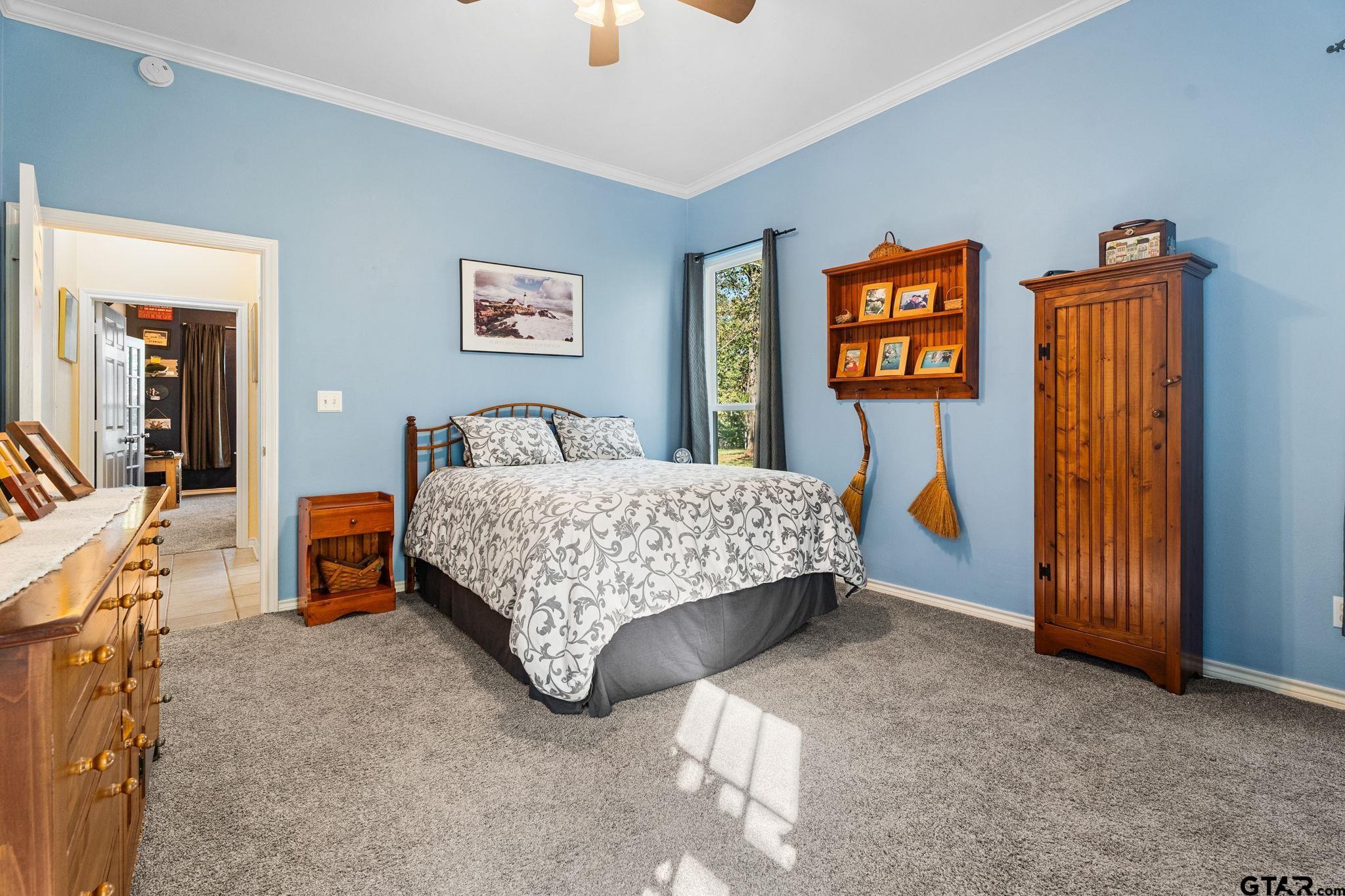 14417 East Ridge Road Arp, TX 75750 - Photo 17 of 47 a bedroom with a bed and a painting on the wall