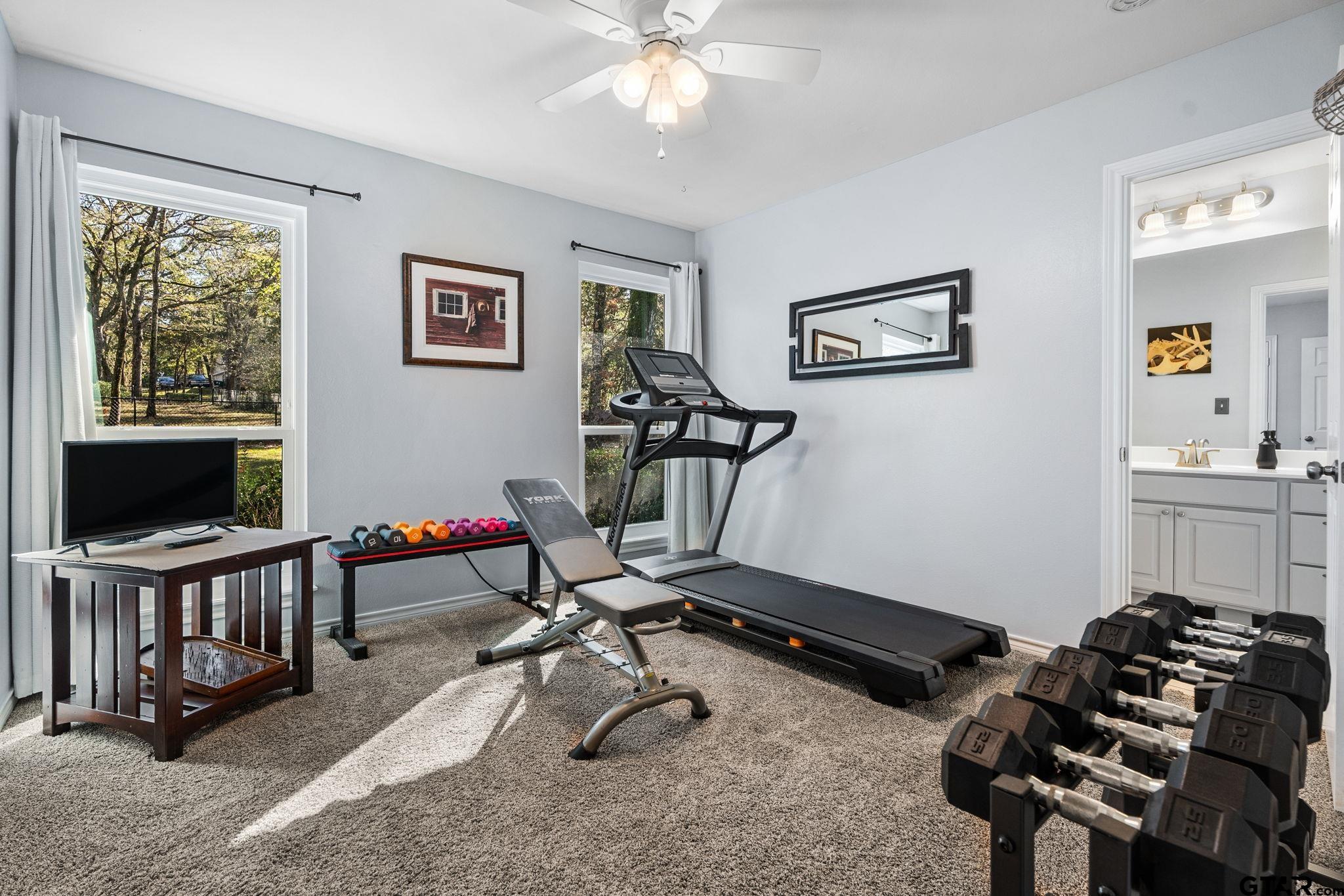 14417 East Ridge Road Arp, TX 75750 - Photo 23 of 47 a room with gym equipment and a flat screen tv