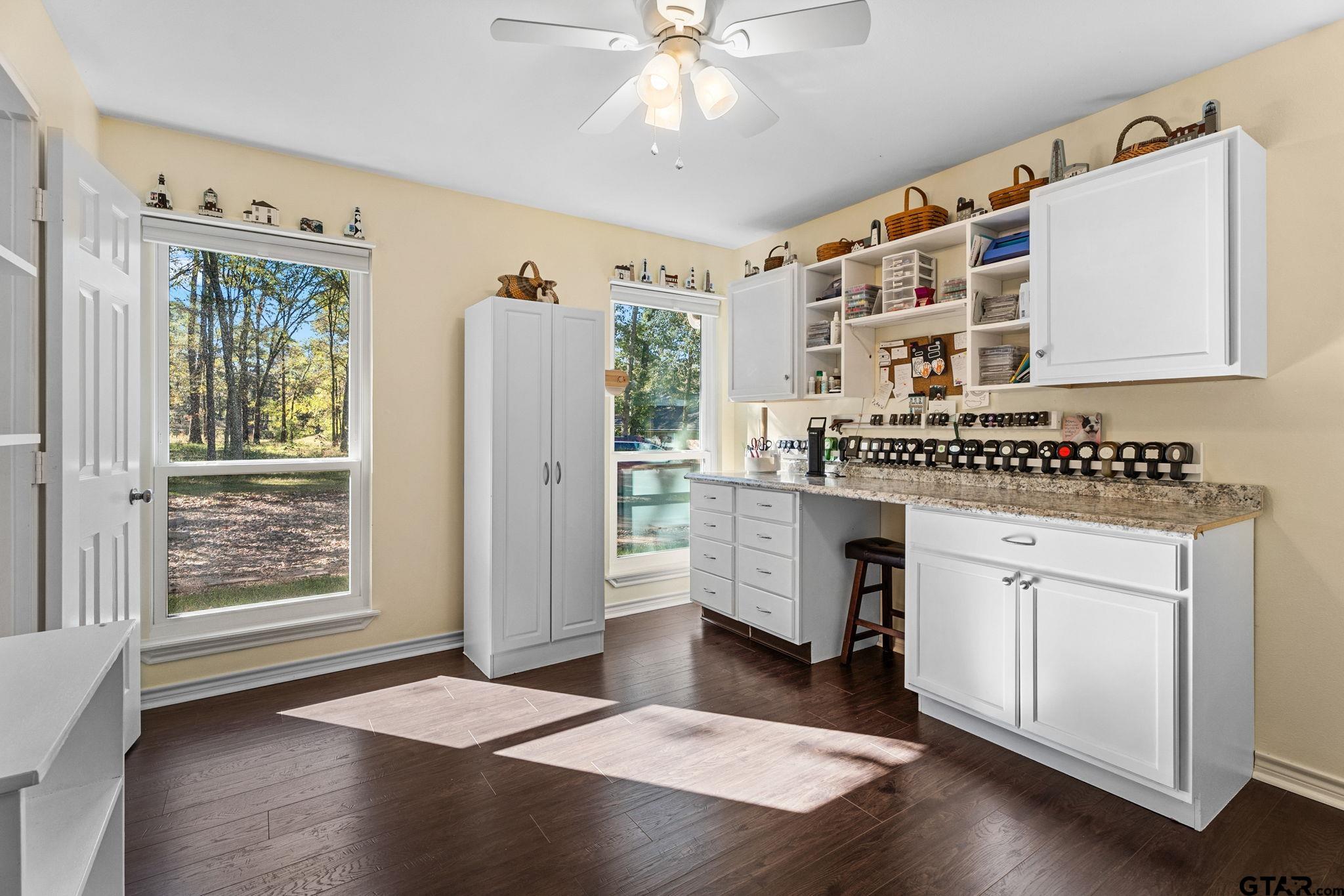 14417 East Ridge Road Arp, TX 75750 - Photo 25 of 47 a kitchen with stainless steel appliances granite countertop a stove a sink and a refrigerator with wooden floor