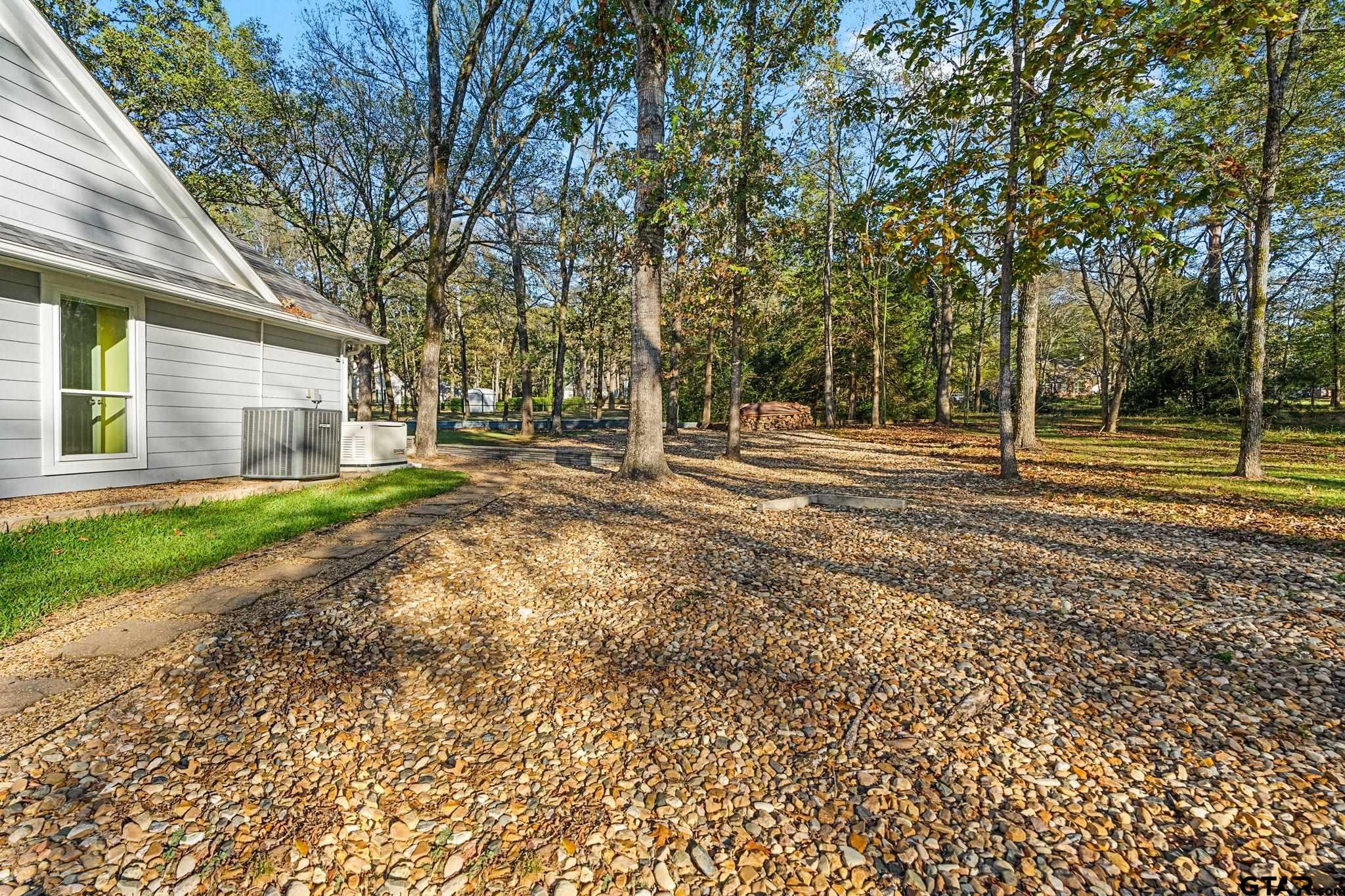14417 East Ridge Road Arp, TX 75750 - Photo 31 of 47 a view of a yard with plants and large trees