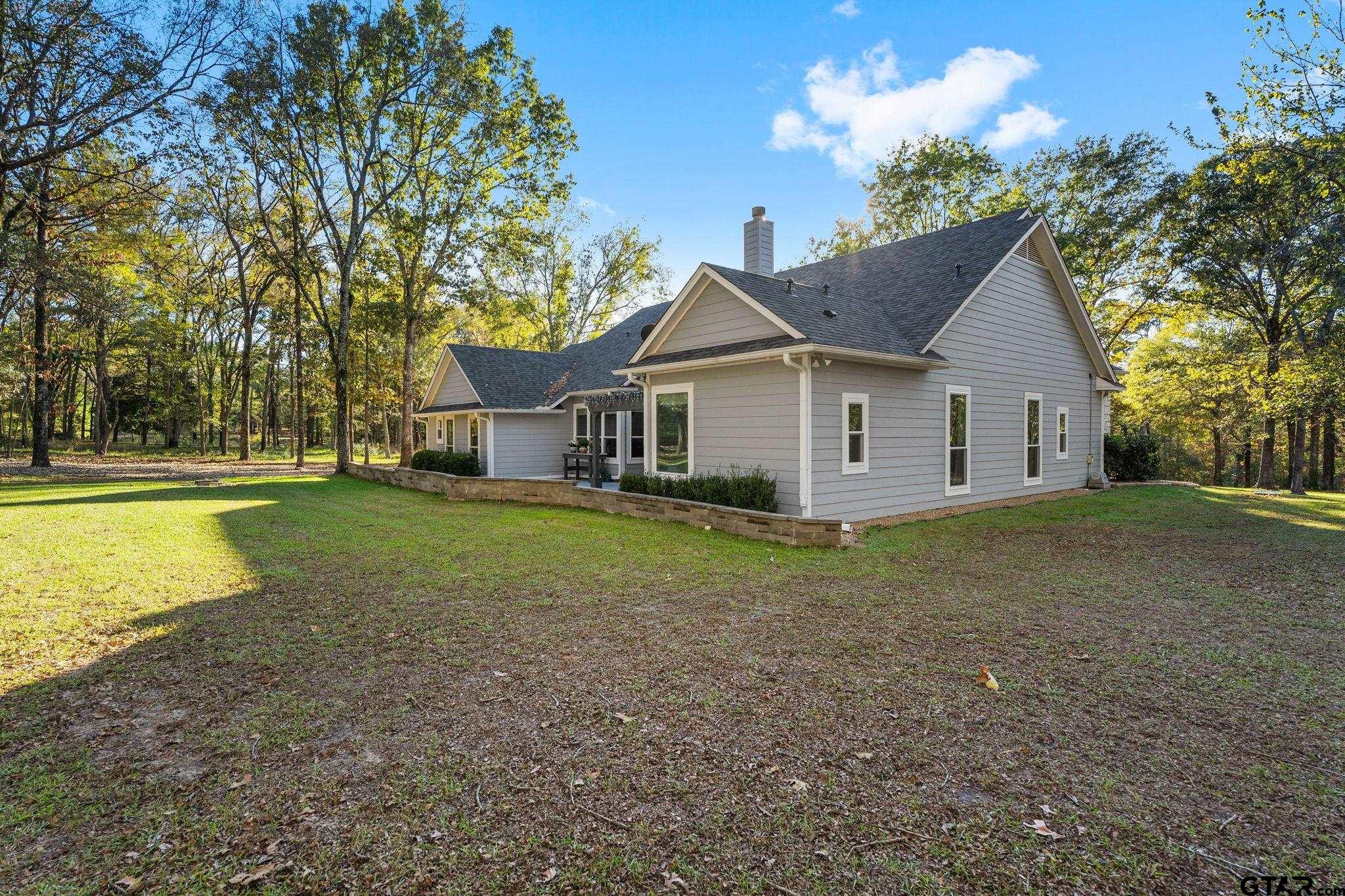 14417 East Ridge Road Arp, TX 75750 - Photo 5 of 47 a view of a house with a yard and large tree