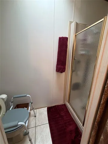 a bathroom with a shower and toilet
