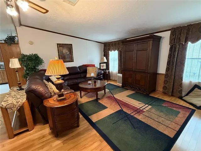 a living room with furniture rug and wooden floor