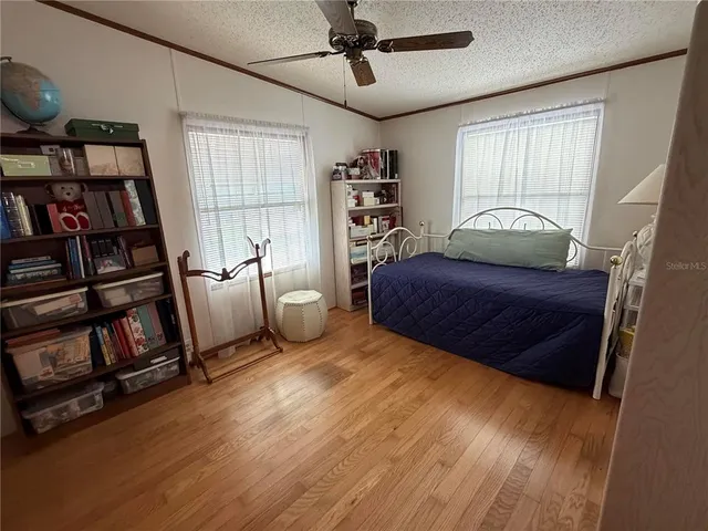 a living room with furniture and a book shelf