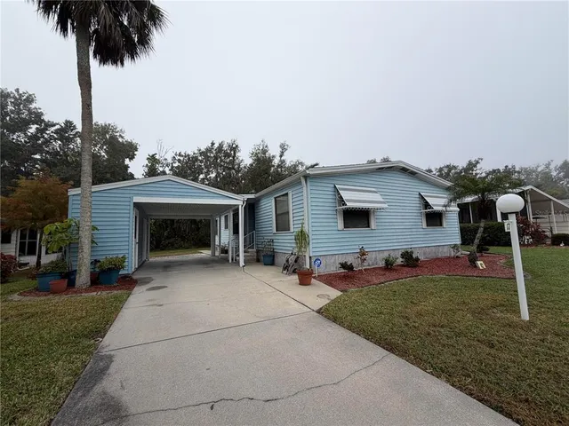 a front view of house with yard and trees