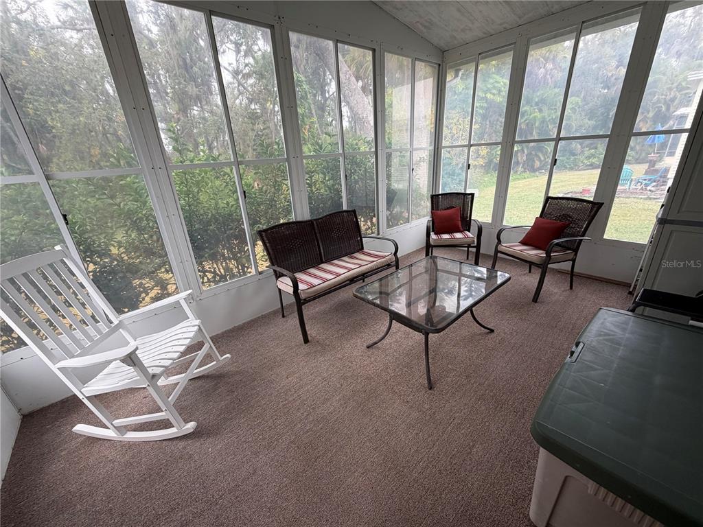 17 Meadowlark Circle Ellenton, FL 34222 - Photo 22 of 25 a living room with furniture and a floor to ceiling window