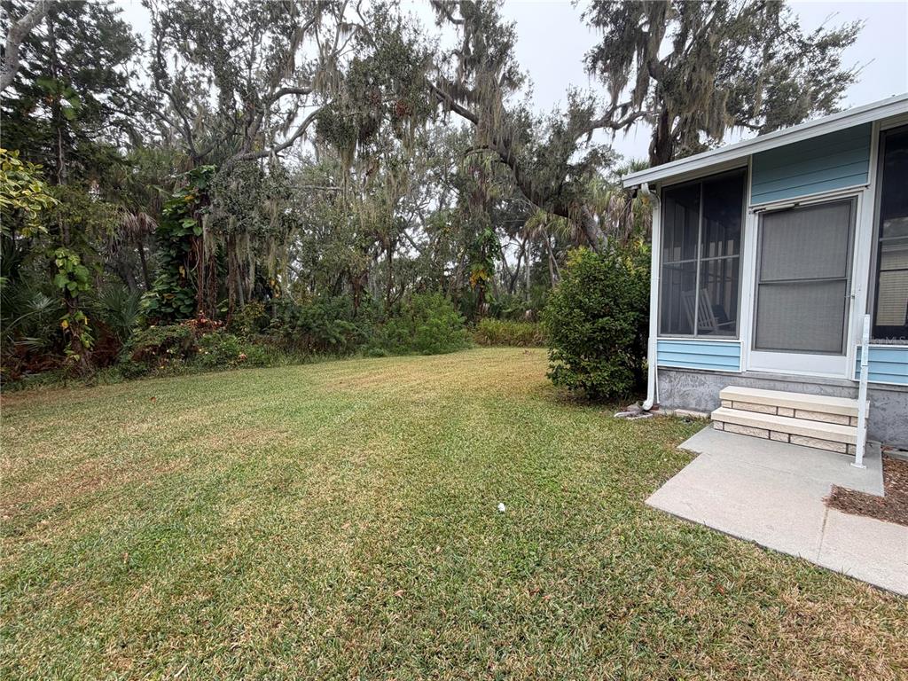 17 Meadowlark Circle Ellenton, FL 34222 - Photo 23 of 25 a view of a backyard with a garden and tree