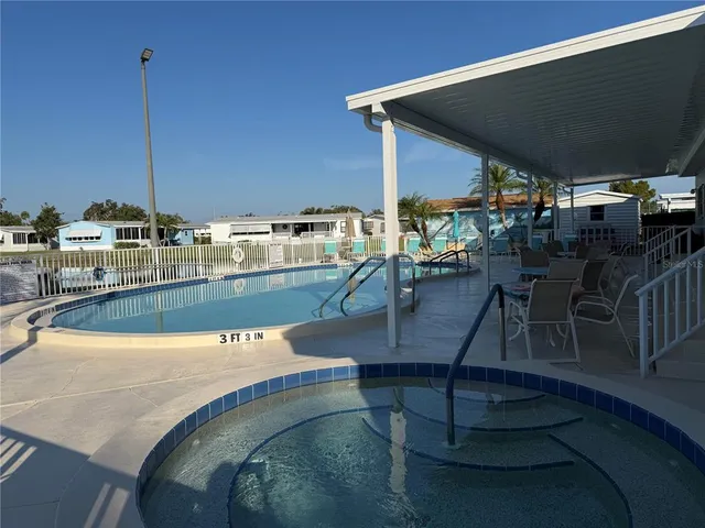 a view of a swimming pool with outdoor seating