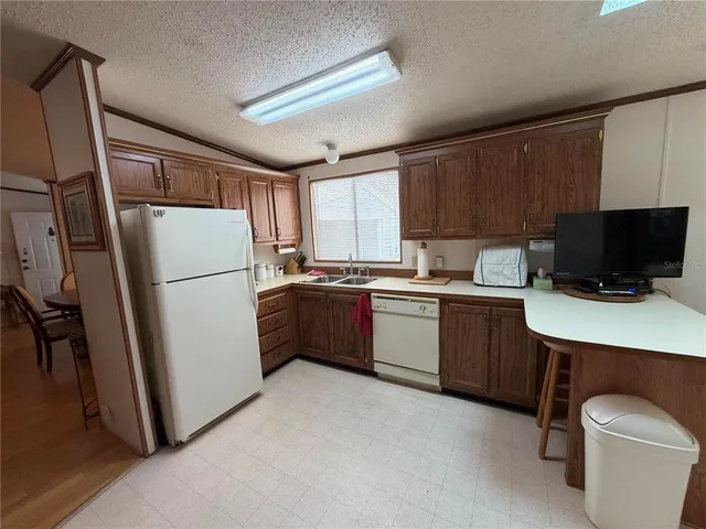a kitchen with a refrigerator stove and microwave