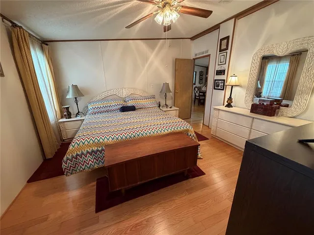 a bedroom with a bed and a large mirror on the dresser