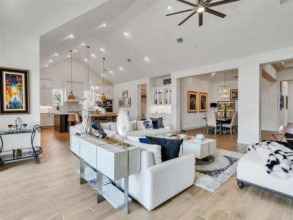 a living room with furniture and a view of kitchen