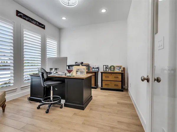 a view of a workspace with furniture and a window