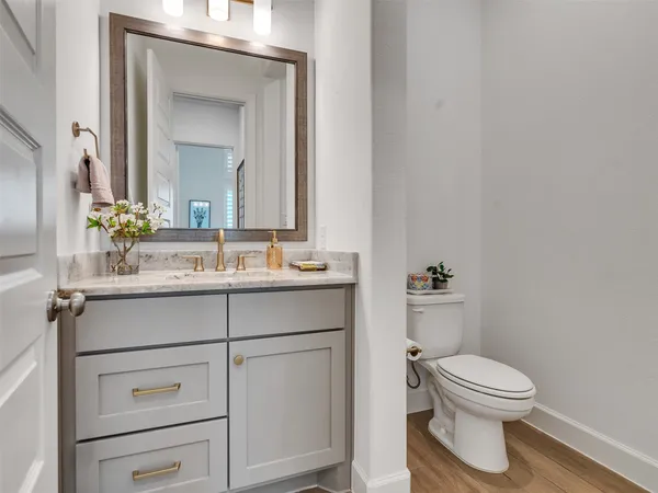 a bathroom with a toilet a sink and mirror