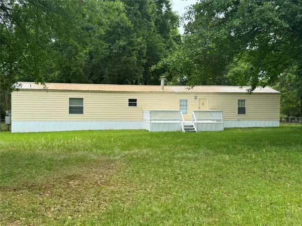 a view of a backyard with table and chairs