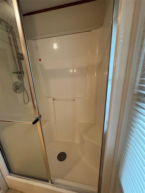 243 Springs Road Frierson, LA 71027 - Photo 16 of 23 a bathroom with a glass door shower