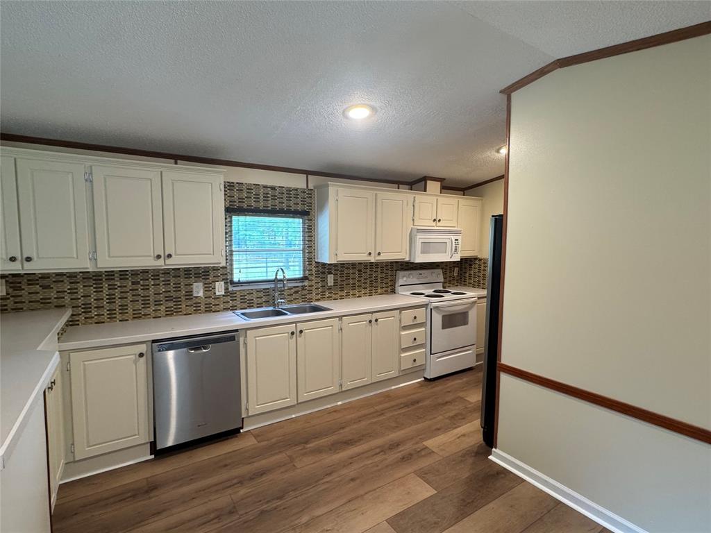 243 Springs Road Frierson, LA 71027 - Photo 8 of 23 a kitchen with granite countertop white cabinets and white appliances