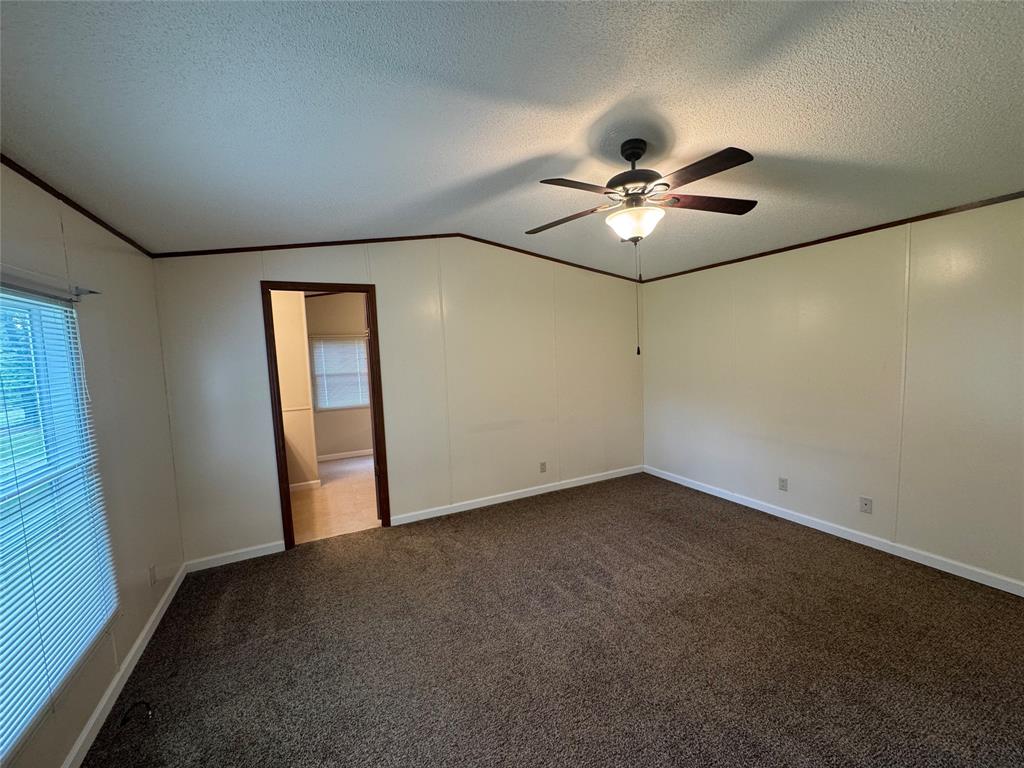 243 Springs Road Frierson, LA 71027 - Photo 9 of 23 an empty room with a chandelier fan and windows