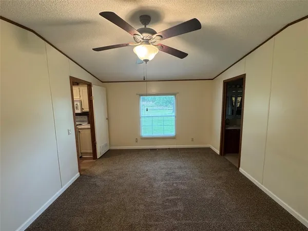 an empty room with closet and windows